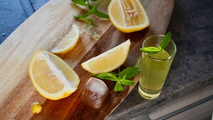 Glass of fresh homemade lemonade with lemon slices, mint, and ice cubes. Refreshing summer drink perfect for healthy lifestyle, detox, or beverage themes.