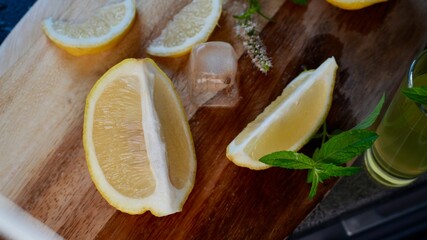 Fresh lemon slices with ice cubes and mint leaves on a wooden surface. Ideal image for summer...