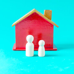 Wooden figure standing toy red house, concept finance growth and property.