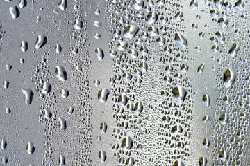 background, unusual, abstract. drops of morning dew, condensation on the glass. wet glass. water drops close-up. beautiful background for text. Spray cool condensate water on the glas