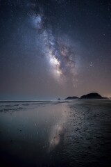 Midnight summer beach landscape with stunning milky way visible Generative AI
