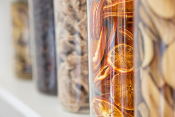 Dried citrus slices in transparent storage jar