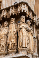 Fototapeta premium Tarragona Cathedral, Tarragona, Catalonia, Spain. Features unique medieval sculptures of apostles and prophets on its grand entrance, including rare female biblical figures—unusual in Gothic portals.