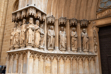 Tarragona Cathedral, Tarragona, Catalonia, Spain. Features unique medieval sculptures of apostles and prophets on its grand entrance, including rare female biblical figures—unusual in Gothic portals.