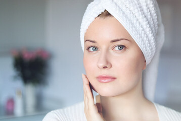 Beauty routine, morning skincare and wellness. A happy smiling beautiful woman with blue eyes and a...