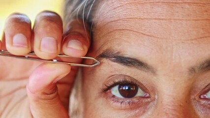 Woman plucking her eyebrows in her van in New Zealand during autumn - Powered by Adobe