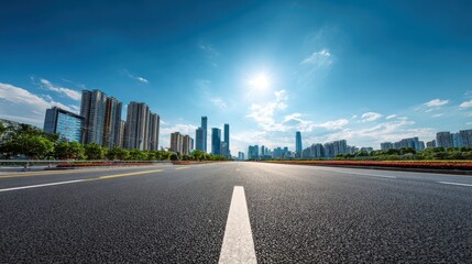 Premium image of empty asphalt highway road and city skyline with residential area buildings under blue sky.