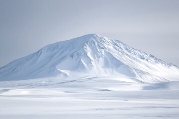 Breathtaking view of a towering snow covered mountain dominating a serene landscape of untouched snow