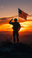 Silhouette of an American soldier holding a flag at sunset
