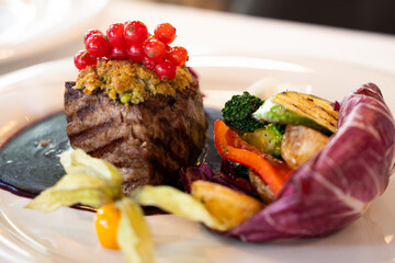Gourmet beef fillet with red currants – fine dining, close-up