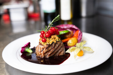 Gourmet steak plating with red currants – close-up