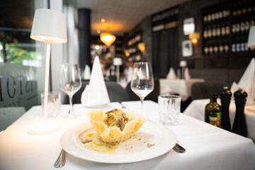 Truffle pasta in parmesan basket – gourmet close-up