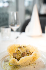Truffle pasta in parmesan basket – gourmet close-up