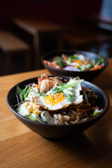 Korean noodle bowl with fried egg – close-up