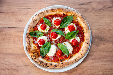 Margherita pizza with cherry tomatoes – top view