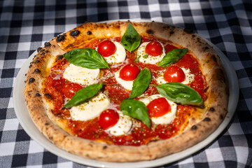 Margherita pizza with cherry tomatoes – top view