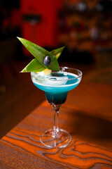 Blue tropical cocktail with garnish – front view