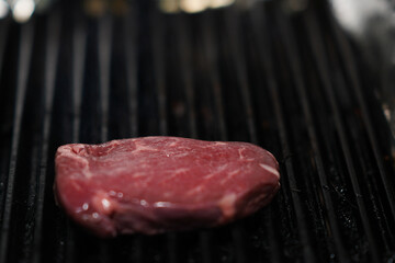 Raw beef steak on grill – close-up