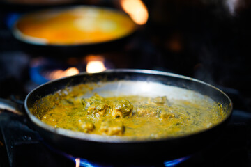 Spicy curry in frying pan – close-up