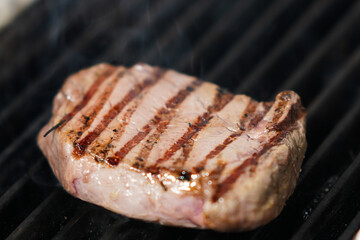 Grilled steak on barbecue – close-up