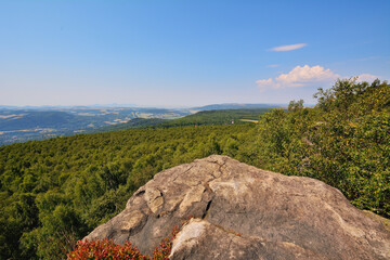 Fototapeta premium Rocky Hilltop in Summer Sunshine with Scenic Forest Landscape
