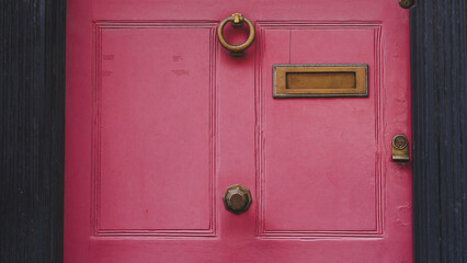 Closeup of English entrance door with brass letterbox and classic home style