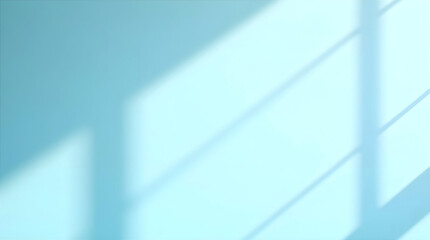 Soft beams of natural light shining across a smooth blue wall creating gentle shadows