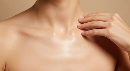 A womans smooth, glowing skin on her neck and collarbone is gently touched by her fingers