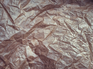 Vintage background from heavily crumpled paper, which is used as a wrapper. The texture of...