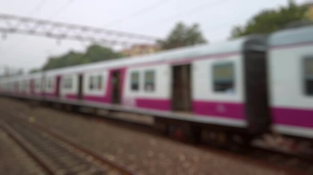 Bokeh view of passenger train ariving at Howrah Junction railway station in Calcutta, India. Blurred background footage.