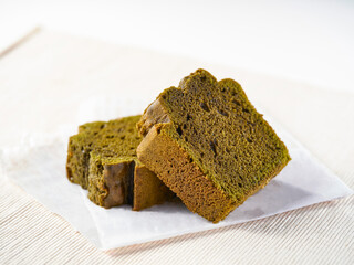 Vibrant Green Matcha Pound Cake Slices on white paper side view of perfect for bakery, dessert and tea time