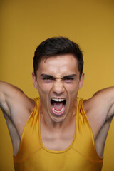 Young Athlete Expressing Determination and Energy During a Training Session in a Studio With a Vibrant Yellow Background