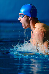 Swimmer Competing in a Race at an Indoor Pool During a Sunny Afternoon