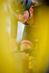 Cyclist Focused on the Race Surrounded by Vibrant Yellow Elements During a Competitive Event