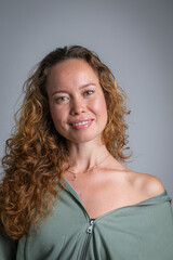 Close-up vertical shot of curly-haired blonde girl smiling