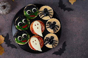 Salty snacks on crackers for Halloween party