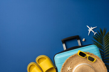 Flat lay arrangement with travel items like a suitcase, hat, and sunglasses, representing vacations