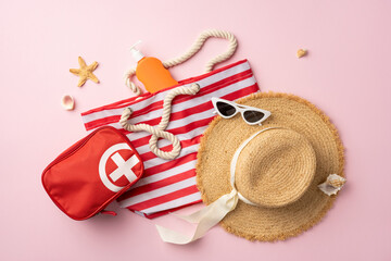 Summer travel essentials including a hat, bag, sunglasses, and first aid kit on a pink background