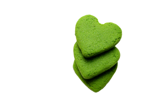 a stack of green cookies with a heart shaped cookie on top