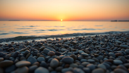 Obraz premium Smooth Pebbles on a Calm Ocean Shore at Sunset