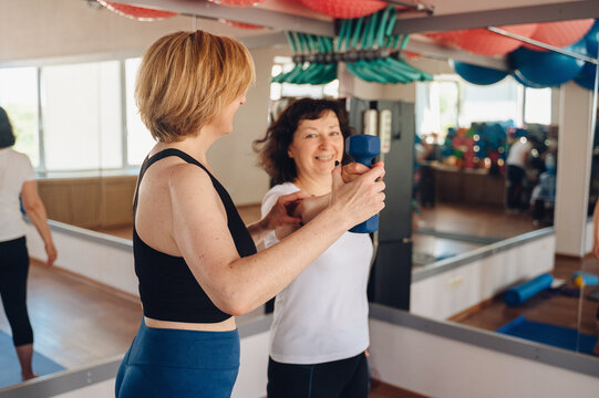 Woman enjoying fitness classes with a female trainer
