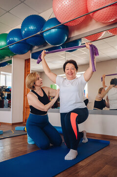 Woman enjoying fitness class with personal trainer