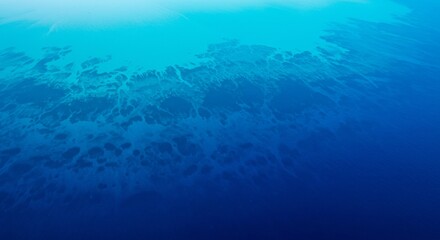 Aerial view of contrasting turquoise and deep blue ocean water patterns