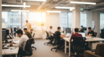 Blurred modern office interior with employees working at computers