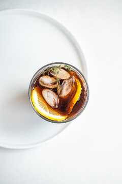 Refreshing gin cocktail with thyme and lemon slice