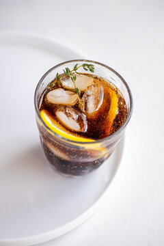 Refreshing gin cocktail with thyme and lemon garnish