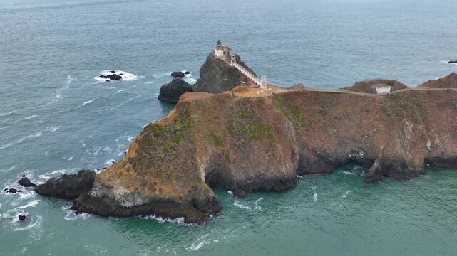 Point Bonita Lighthouse in cloudy day with fog at Point Bonita at San Francisco Bay in Marin Headlands in Marin County, California CA, USA. This lighthouse is in Golden Gate National Recreation Area. 