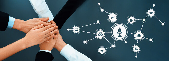 A group of diverse hands in a professional setting symbolizes collaboration and teamwork,...