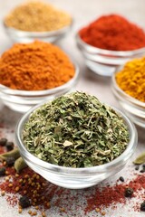 Different aromatic spices on light grey table, closeup