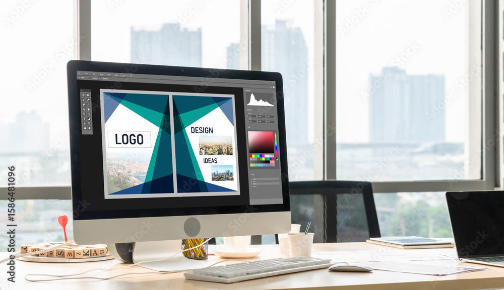 Poster graphic designer software for modern design of web page and commercial ads showing on the computer s
